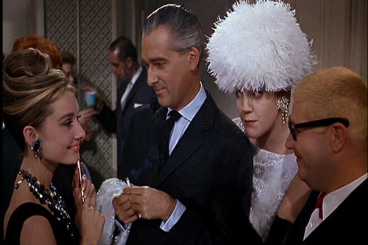 Holly with prospective rich husbands in Breakfast at Tiffany's.